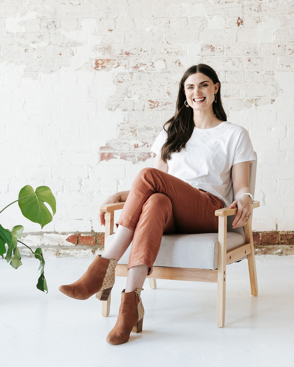 Kaity Griffin Google Ads expert smiling white sitting in a chair with legs crossed